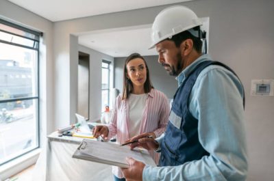 Latin American woman talking to a contractor while remodeling her house